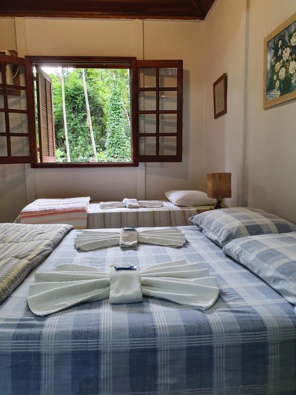 Postel nebo postele na pokoji v ubytování Pousada Canto do Curió Paraty
