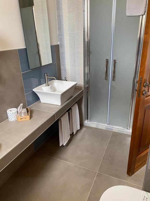 a bathroom with a sink and a shower at Tenute Plaia Agriturismo in Scopello