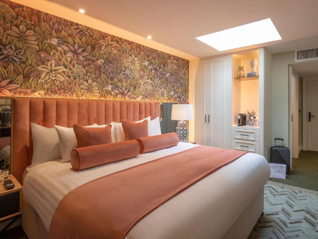 a bedroom with a large bed with a wall mural at HYDE Hotel in Galway