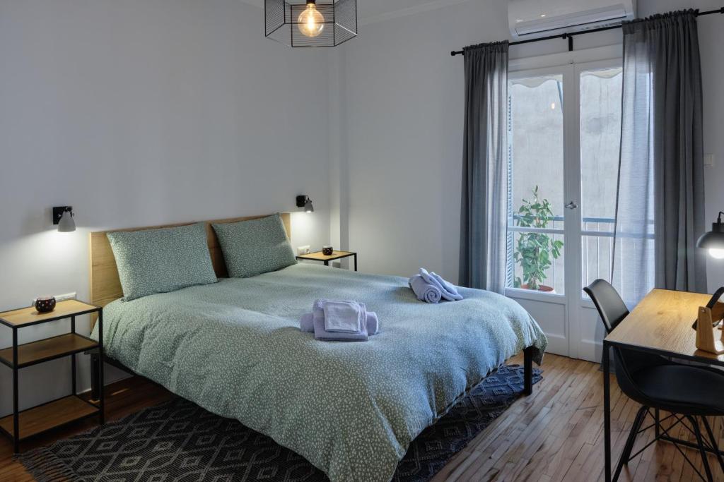 um quarto com uma cama e uma grande janela em K1 Apartment em Atenas