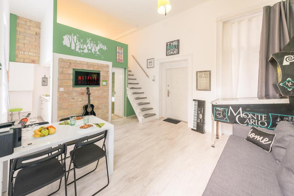 a living room with a couch and a table in it at happy home FOX - apartment with free Pinball Machine in Budapest