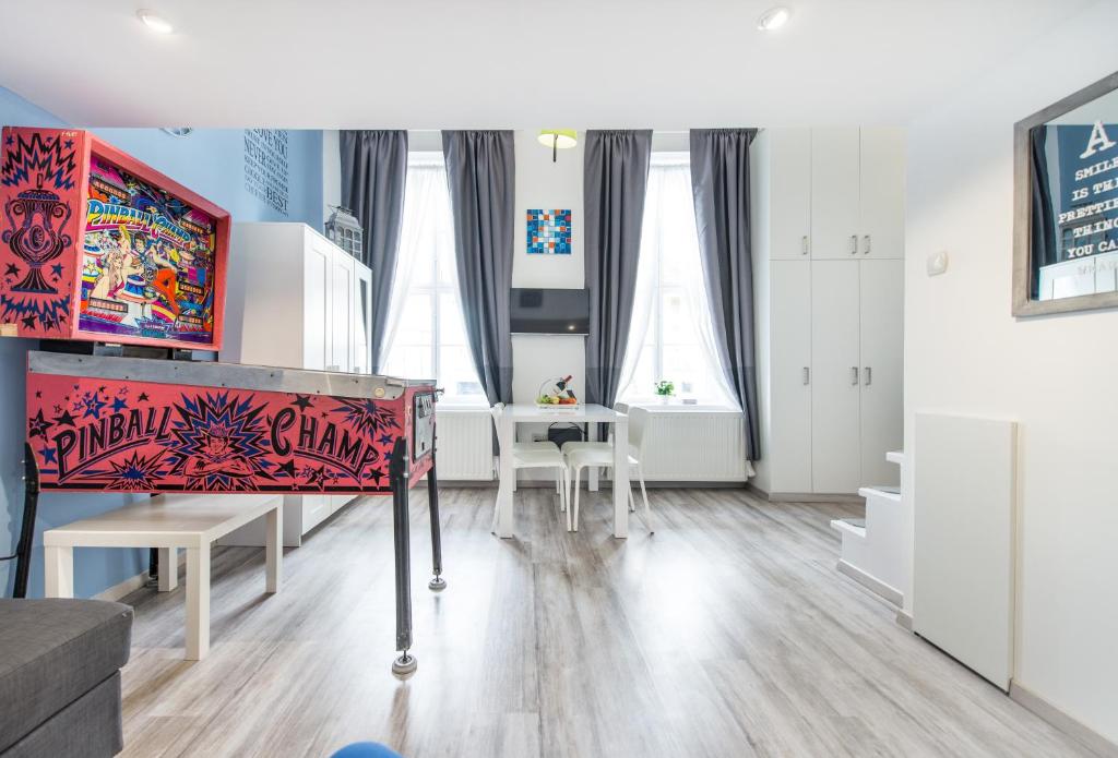 a living room with a couch and a table at happy home BLUE - apartment with free Pinball Machine in Budapest