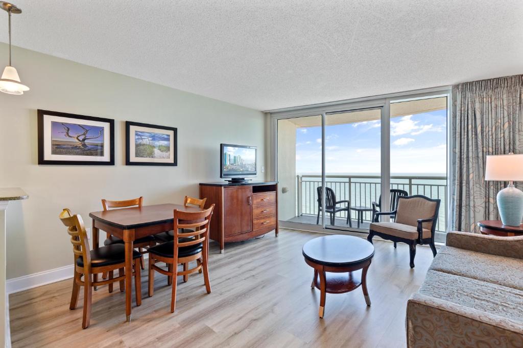 a living room with a table and a couch at Sandy Beach Resort in Myrtle Beach
