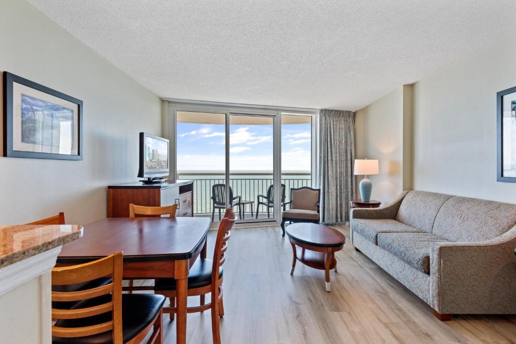 a living room with a couch and a table at Sandy Beach Resort in Myrtle Beach