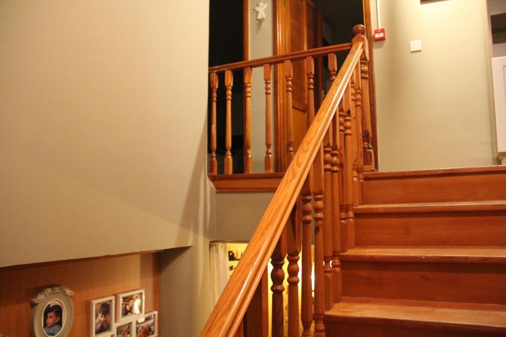 a staircase in a home with wooden railings at Balim Sultany in Çeşme