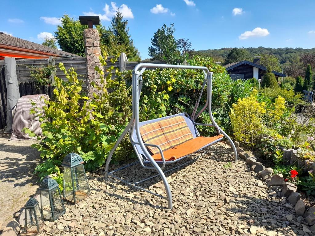 a swing in the middle of a garden at Haus mit Blick auf den Lister See in Meinerzhagen