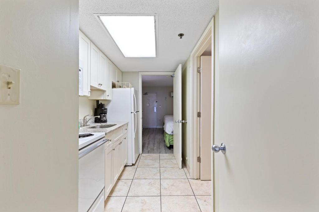 a kitchen with white cabinets and a skylight at Sandy Beach Resort in Myrtle Beach
