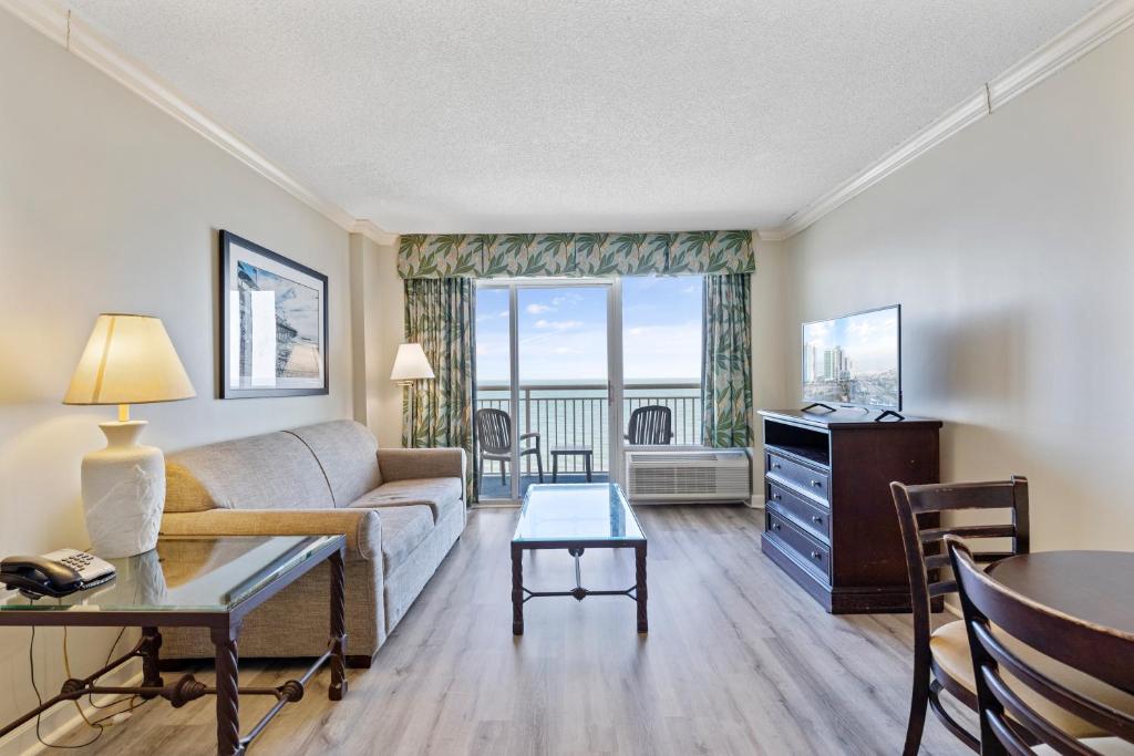 a living room with a couch and a table at Sandy Beach Resort in Myrtle Beach