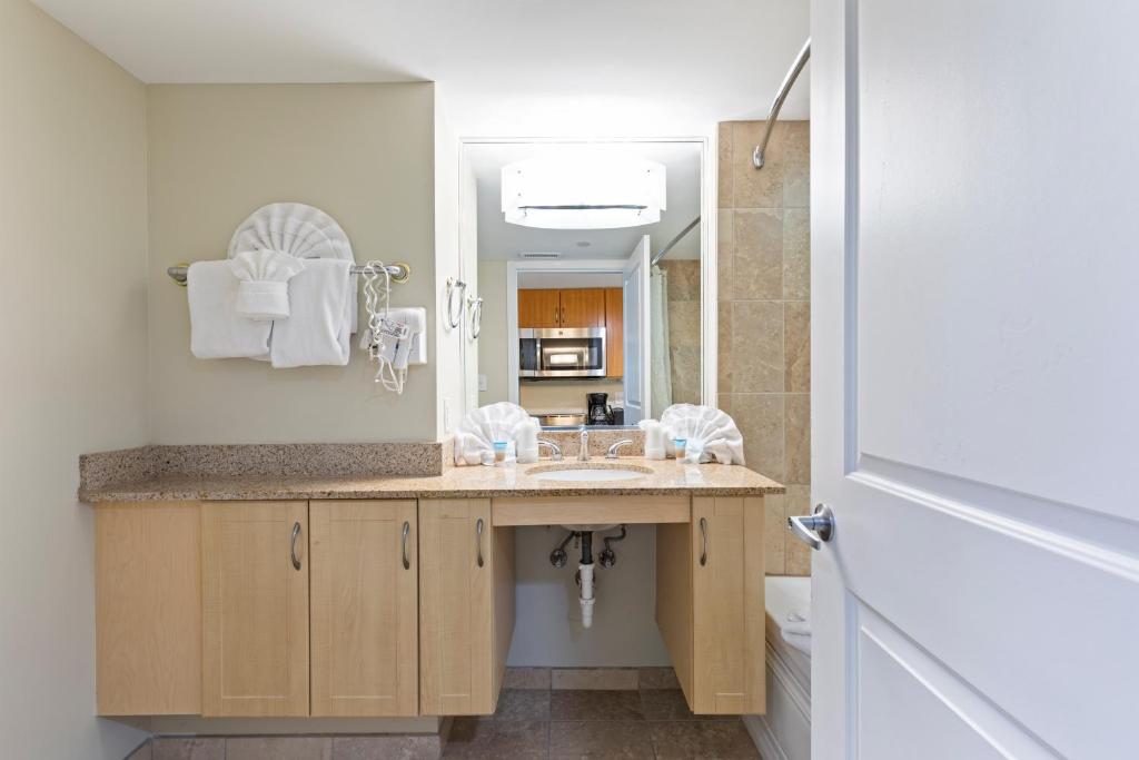 a bathroom with a sink and a mirror at Sandy Beach Resort in Myrtle Beach