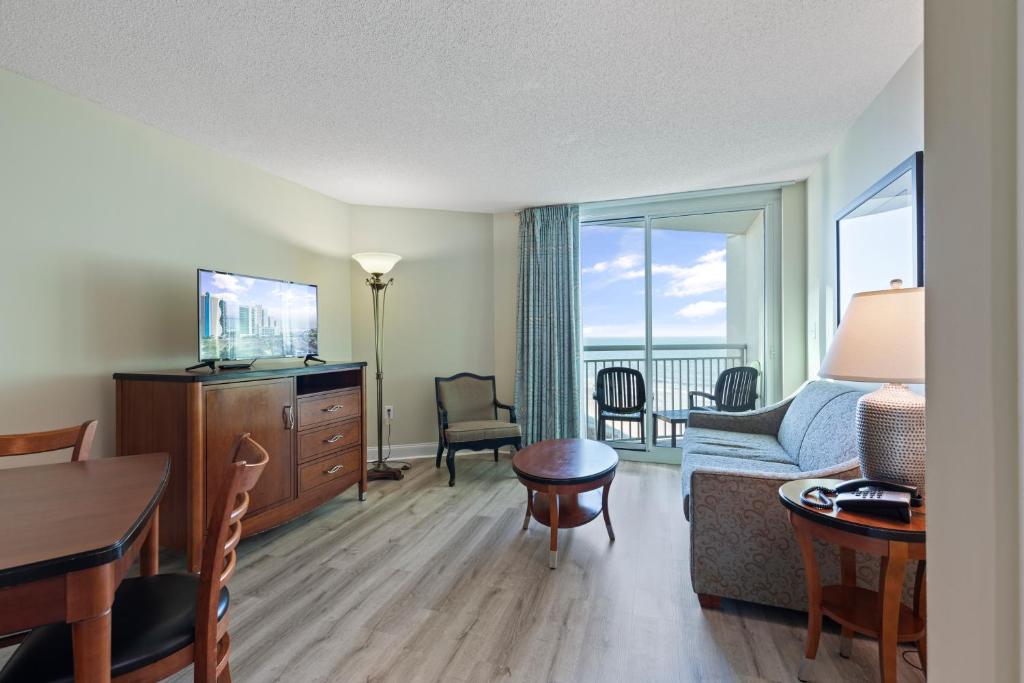 a living room with a couch and a table at Sandy Beach Resort in Myrtle Beach