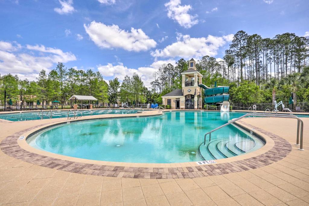 a swimming pool at a resort at Cheery Condo with Community Pool and Waterslide! in Pine Bluff