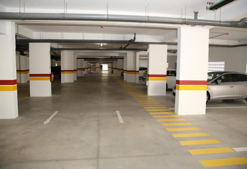 an empty parking garage with cars parked in it at Hotel Rural Brícia Du Mar in Ferragudo