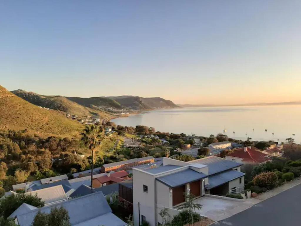 an aerial view of a town with a body of water at Stonebrook Apartments in Simonʼs Town