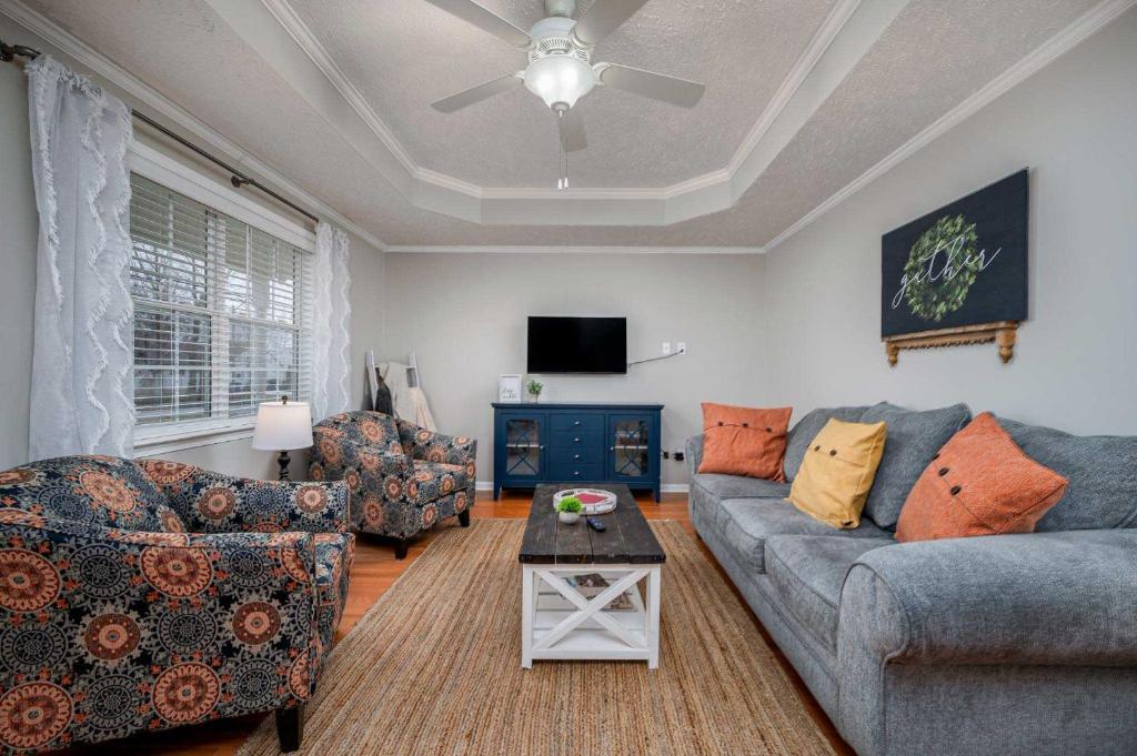 a living room with two couches and a tv at Single-Story Manchester Home Close to Parks! in Manchester