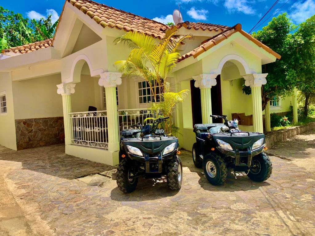 two motorcycles parked in front of a house at Villas Garcia in Las Terrenas