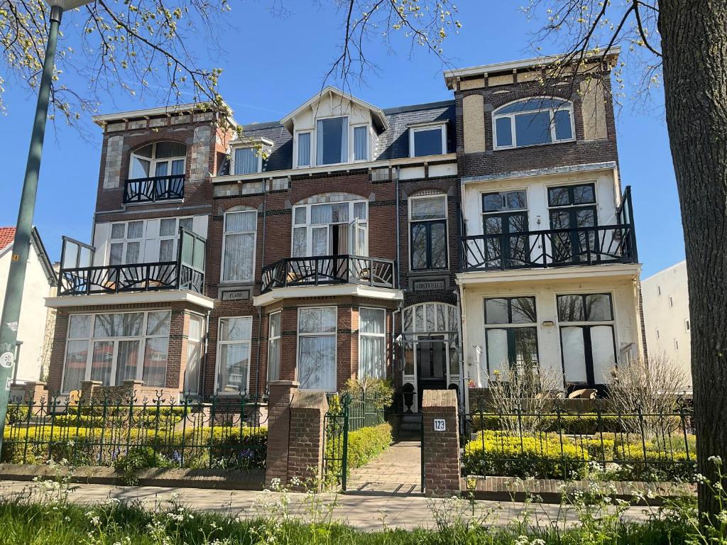 a large brick house on a sunny day at Aristoteles Apartments in Scheveningen