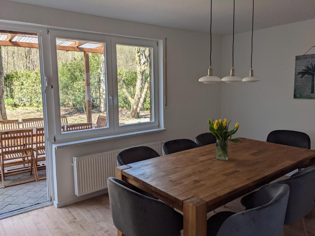 a dining room with a wooden table and chairs at Haus Eisfenn in Blankenheim