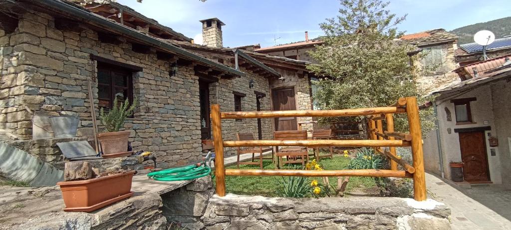 a house with a wooden fence in a yard at Ca' de Baci' du Mattu in Mendatica