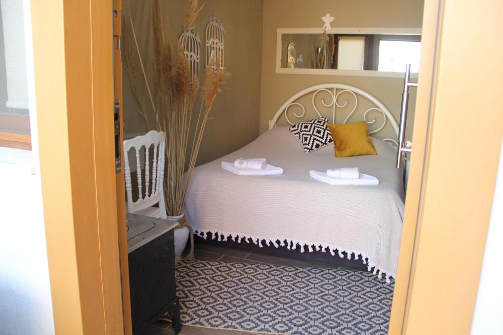 a bedroom with a white bed with two shoes on it at Balim Sultany in Çeşme