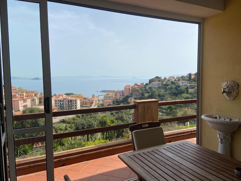 a balcony with a table and a view of the ocean at Villa Maurizio in Rio Marina