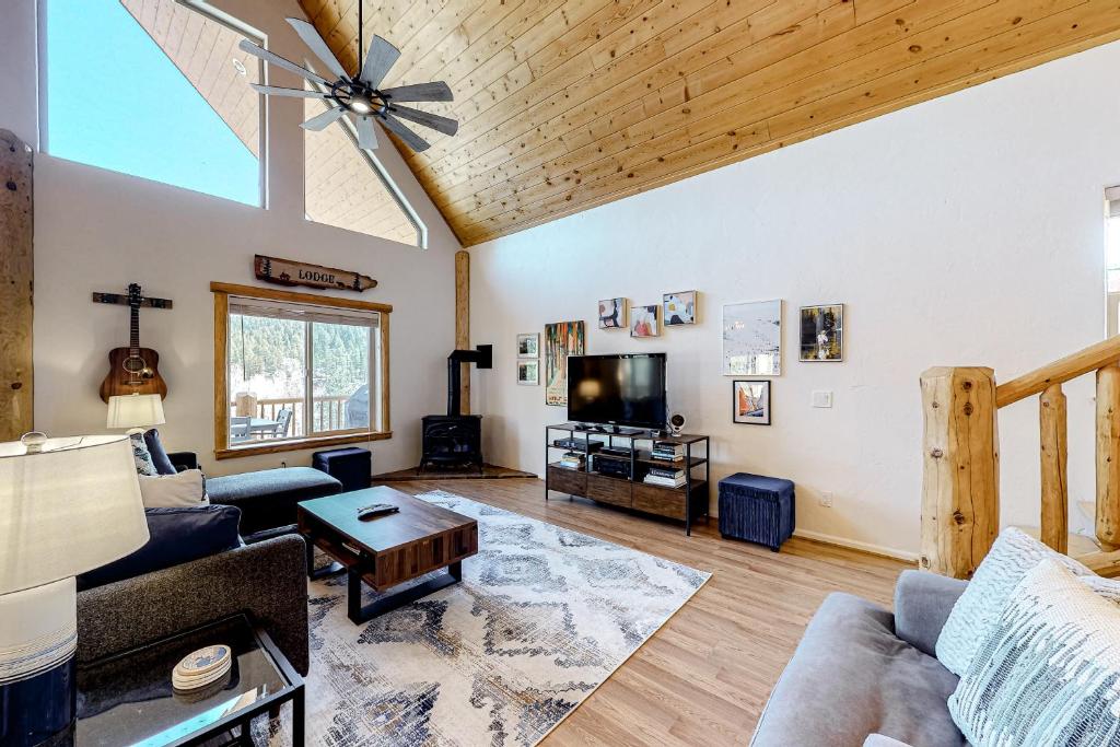 a living room with a couch and a table at Riverfront Lodge in Pagosa Springs