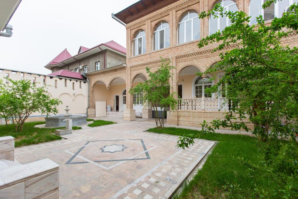 a building with a courtyard in front of it at New Friends Mini-Hotel in Tashkent
