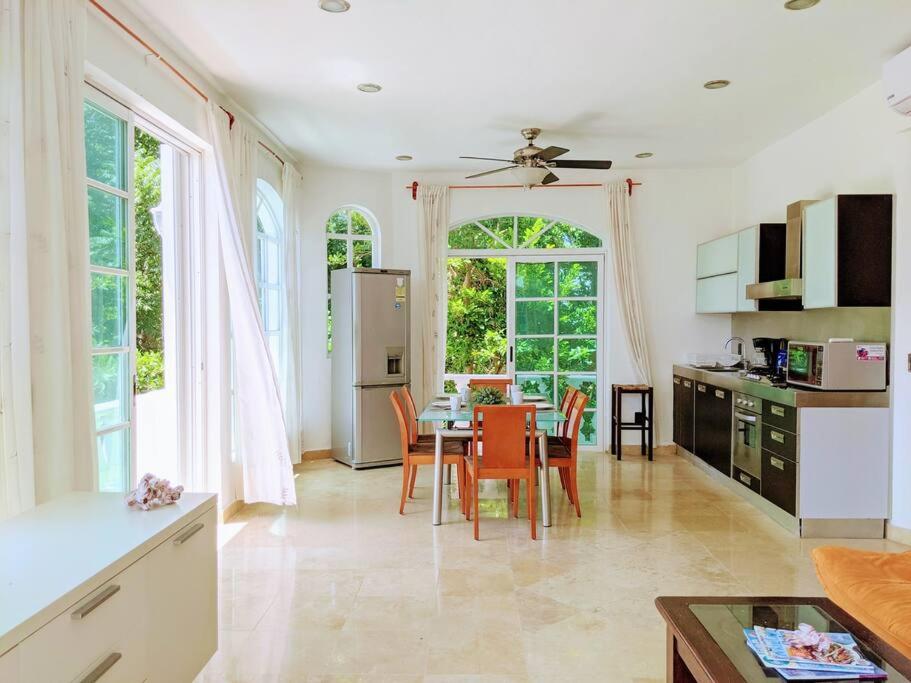 a kitchen and dining room with a table and chairs at 3br PHouse Rooftop terrace with plunge pool and ocean view walk to beach 5th ave and Cozumel Ferry in Playa del Carmen