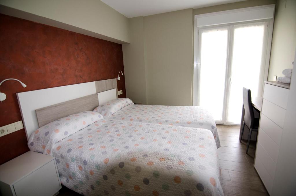 Postel nebo postele na pokoji v ubytování Pensión Ibai Ega