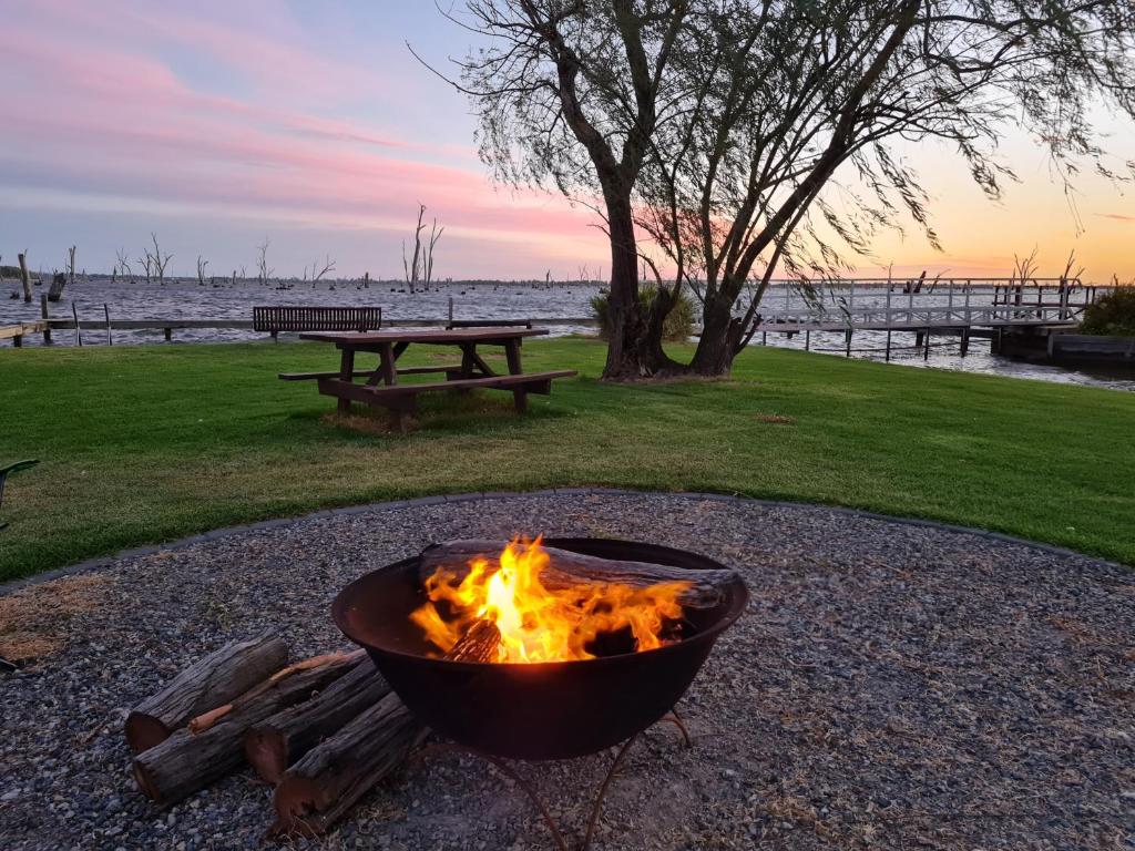a fire pit in a park next to a picnic table at Tasman Holiday Parks - Lake Mulwala in Mulwala