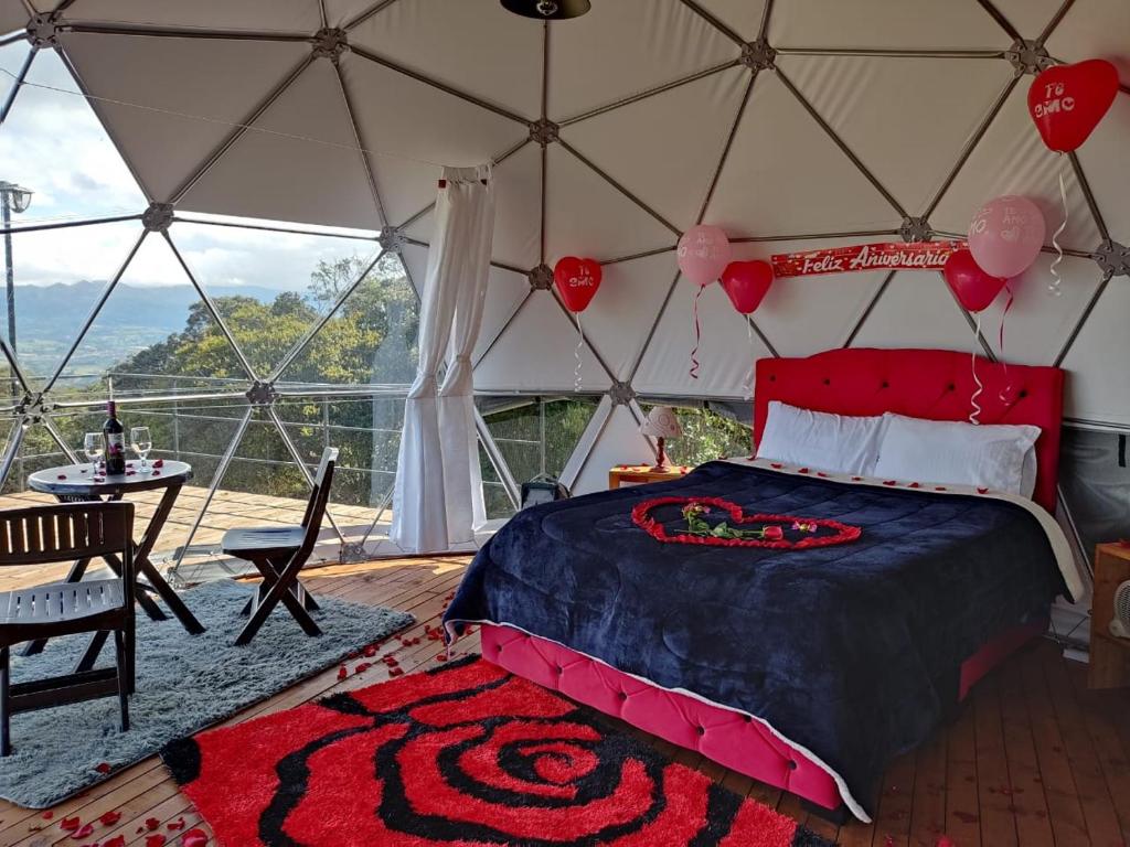 a bedroom in a yurt with a bed and a table at Glamping hermoso amanecer in Guatavita