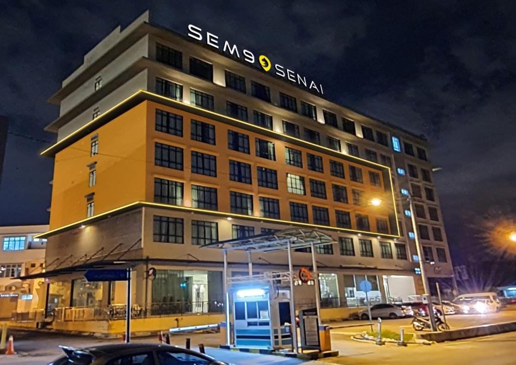 a building with a gas station in front of it at SEM9 Senai "Formerly Known As Perth Hotel" in Kulai