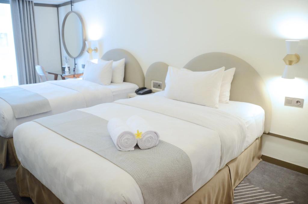 Postel nebo postele na pokoji v ubytování Louis Kienne Hotel Pemuda