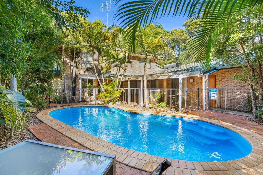 an image of a swimming pool in front of a house at Amaroo Rainbow Shores in Rainbow Beach