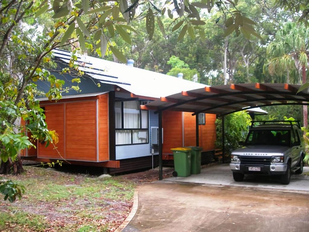 a small house with a car parked in front of it at 43 Satinwood Drive Rainbow Shores in Rainbow Beach