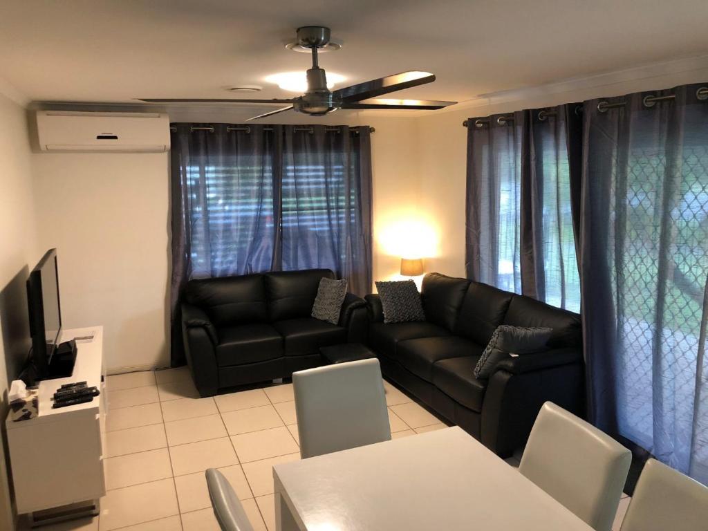 a living room with a couch and a table at Palmgrove 1 Rainbow Beach in Rainbow Beach