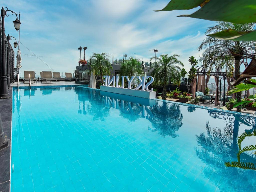 a large swimming pool with blue water at Hanoi Tirant Hotel in Hanoi