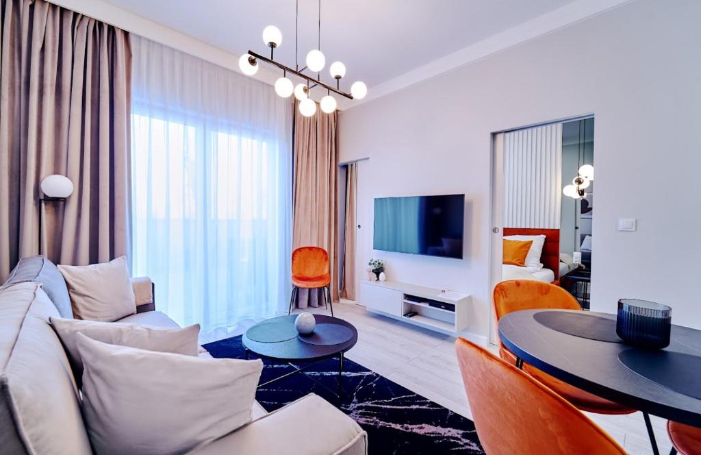 a living room with a couch and a table at LAGUNA Apartament Polanica Residence 3 in Polanica-Zdrój