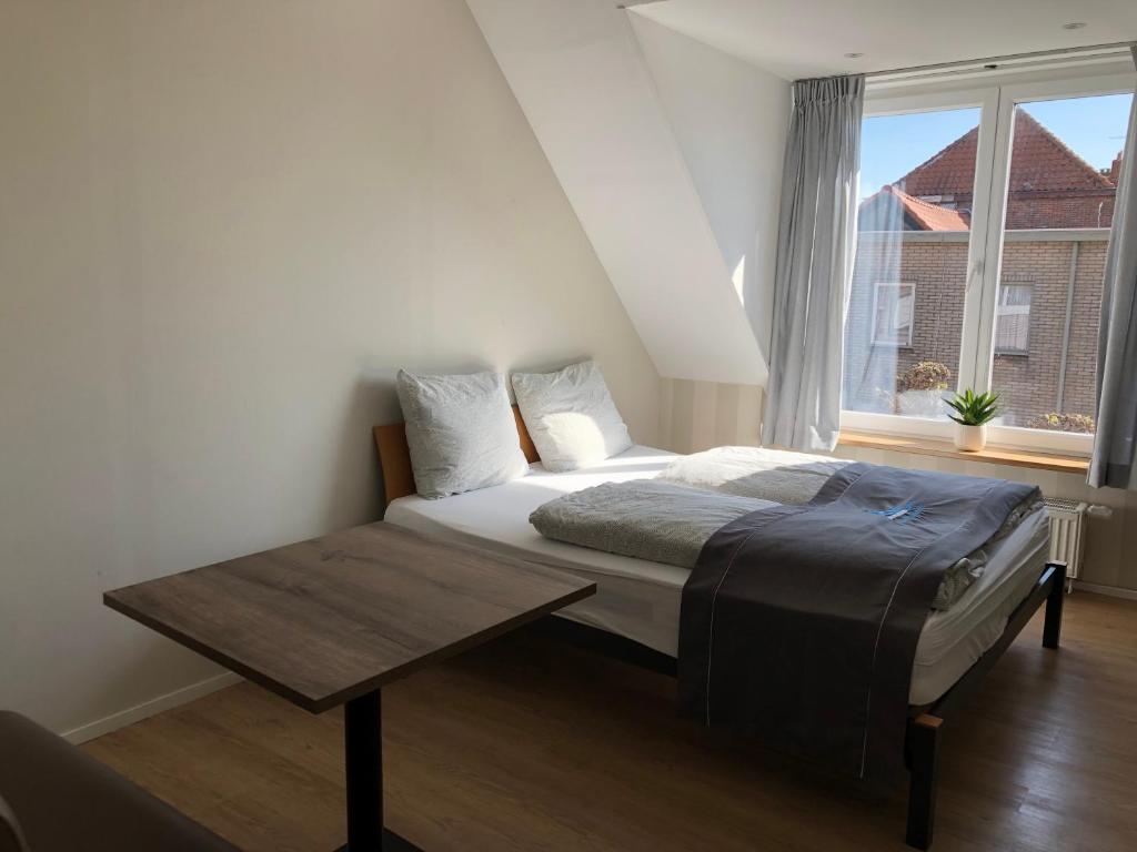 Säng eller sängar i ett rum på Residence De Kaaipoort appartementen