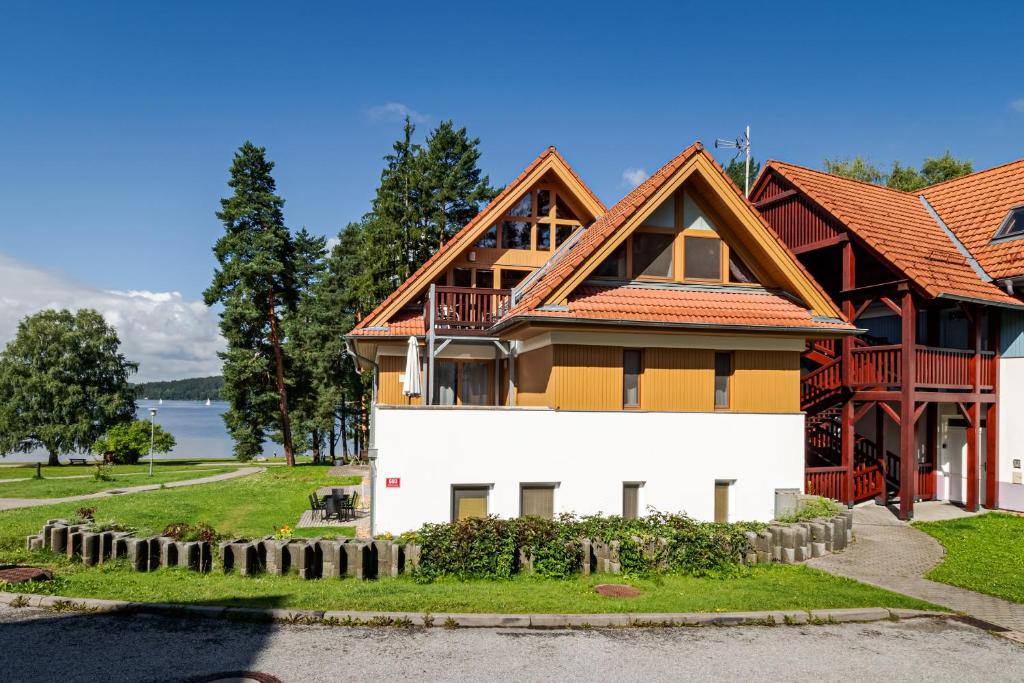 a large house with a wooden roof at Riviera Lipno 503 - 15 in Lipno nad Vltavou