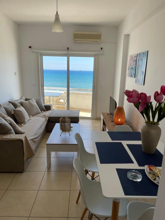 a living room with a couch and a table at Alex Beach Apartment 31 in Larnaca