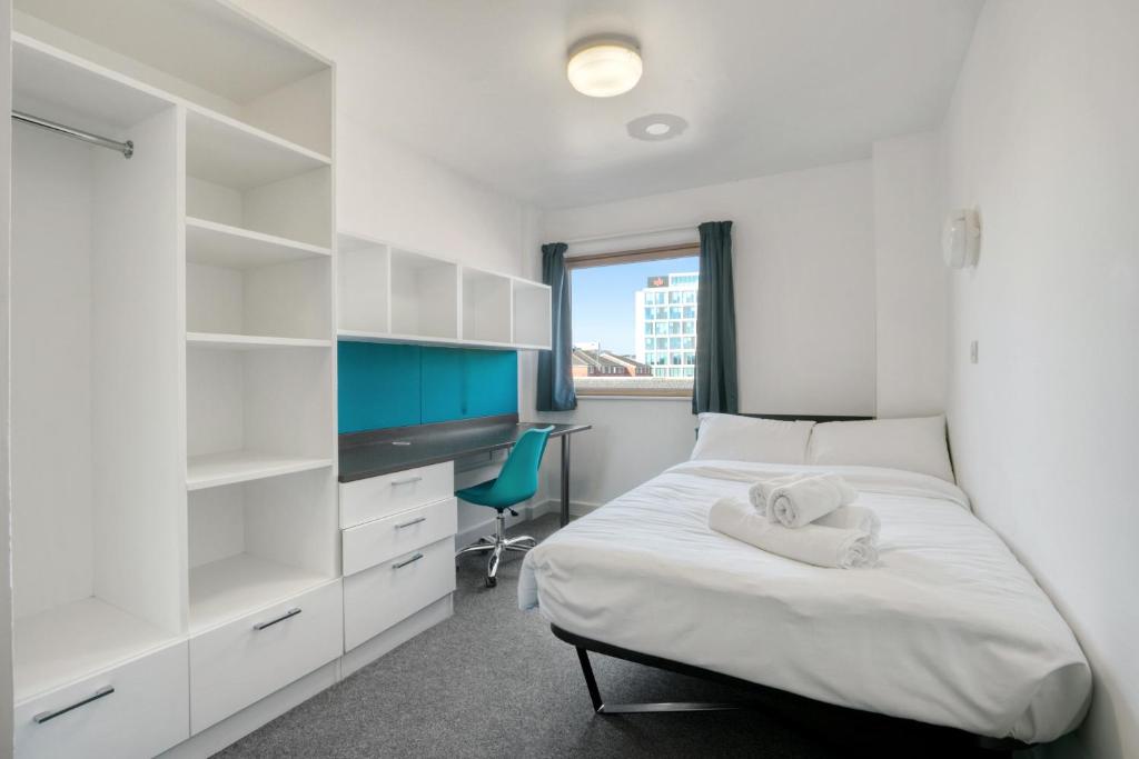 a white bedroom with a bed and a desk at Bright & Central Room in Luton, Sleeps 2 in Luton