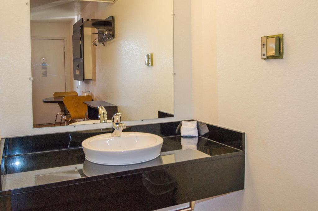 a bathroom with a sink and a mirror at Motel 6-Ardmore, OK in Ardmore