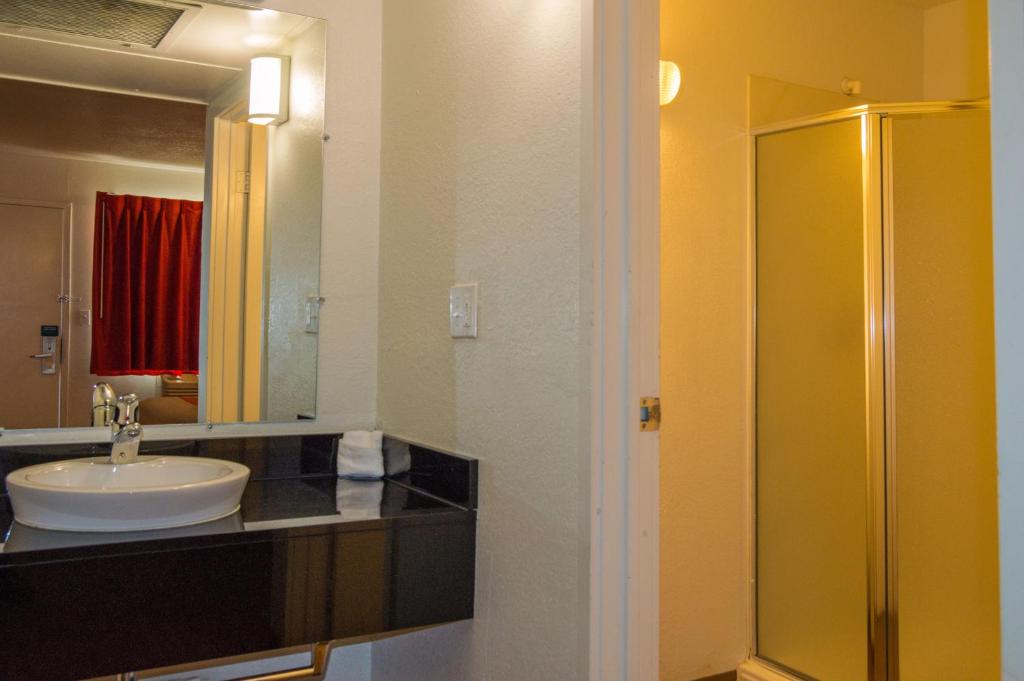 a bathroom with a sink and a shower at Motel 6-Ardmore, OK in Ardmore
