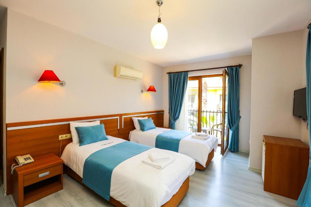 Postel nebo postele na pokoji v ubytování Gocek Unlu Hotel