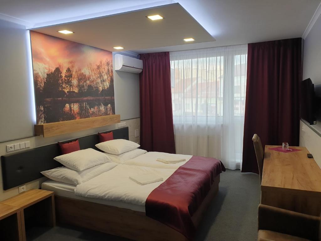 Postel nebo postele na pokoji v ubytování Hotel Strážnice