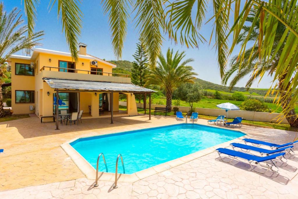 a villa with a swimming pool and a house at Villa Noni Large Private Pool AC WiFi in Polis Chrysochous