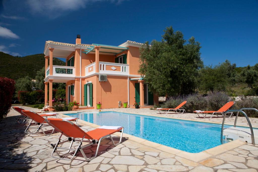 a villa with a swimming pool in front of a house at Pantheon & Danae Luxury Villas in Sivota