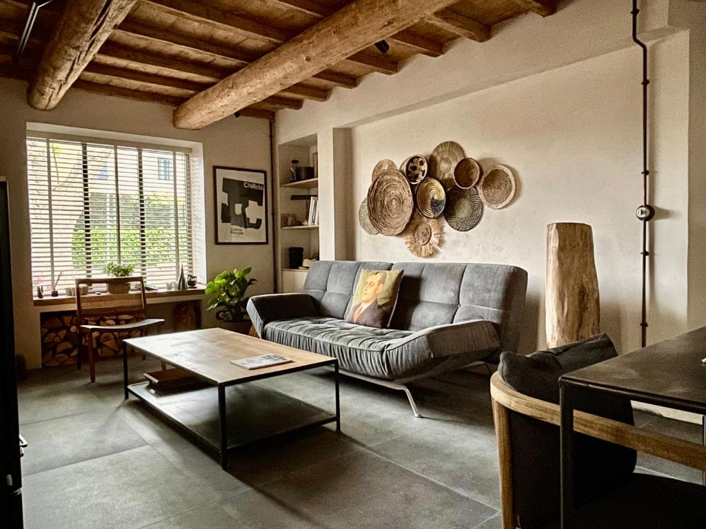 a living room with a couch and a table at La Blanchisserie in Maussane-les-Alpilles
