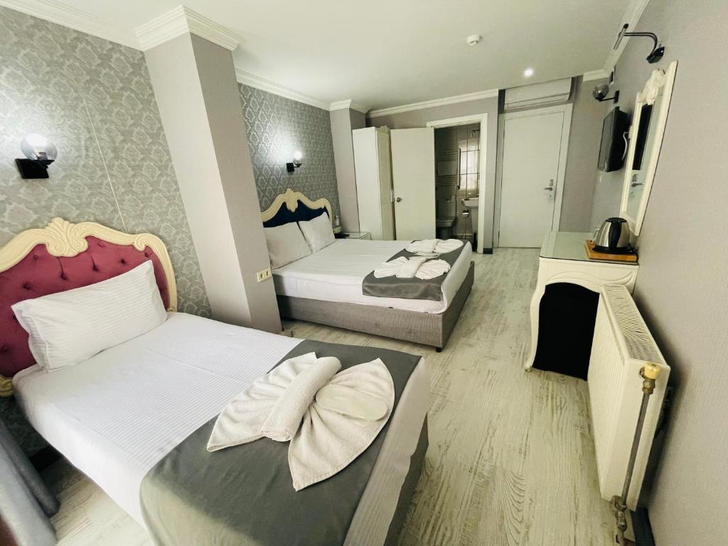Postel nebo postele na pokoji v ubytování Old City Viva Hotel