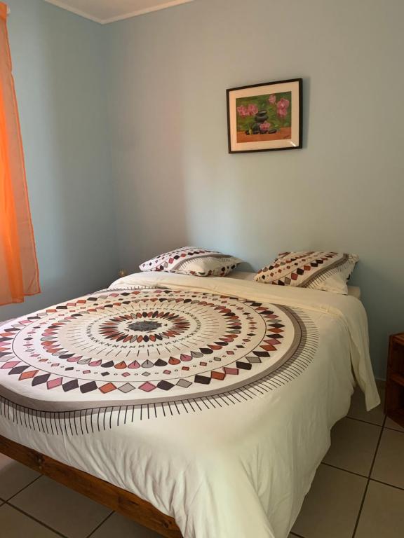 a bedroom with a bed with a mandalaspread on it at Les Thuyas in Cilaos